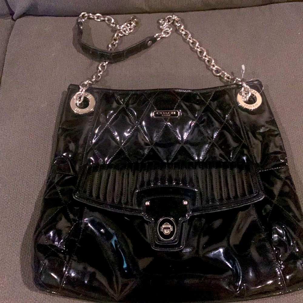 Coach Poppy Gloss Black patent leather crossbody purse with metal strap.